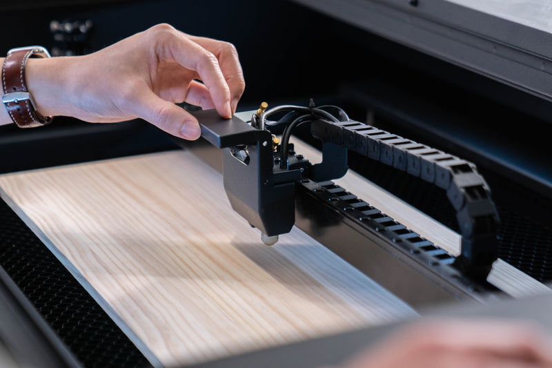 FLUX Hexa 60W Lasergerät graviert Logos und schneidet Materialien wie Holz und Acryl für vielseitige Anwendungen in Produktion und Design.